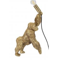 Lampada da tavolo in resina dorata a forma di gorilla che tiene in mano la lampadina