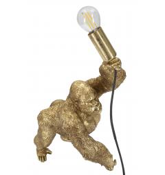 Lampada da tavolo in resina dorata a forma di gorilla che tiene in mano la lampadina