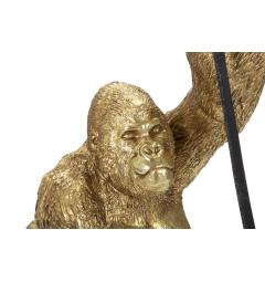 Lampada da tavolo in resina dorata a forma di gorilla che tiene in mano la lampadina