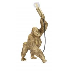 Lampada da tavolo in resina dorata a forma di gorilla che tiene in mano la lampadina