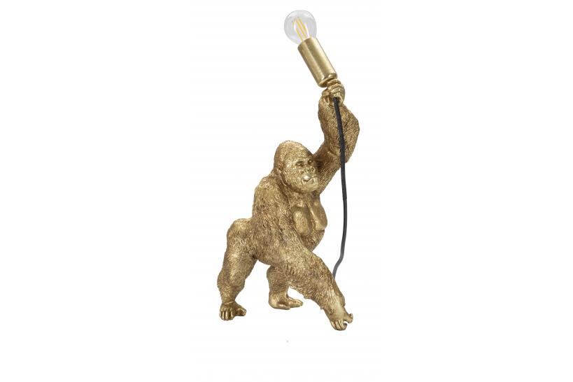 Lampada da tavolo in resina dorata a forma di gorilla che tiene in mano la lampadina