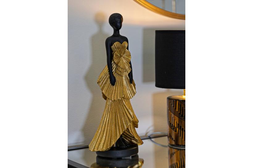 Statuetta a forma di donna con elegante vestito da sera dorato